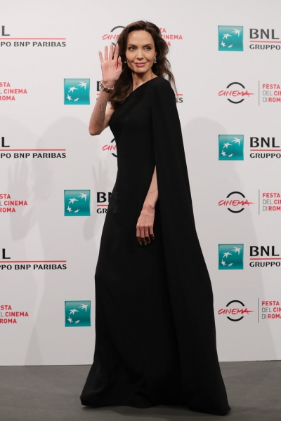 Итальянской диве подобна: смеющаяся Анджелина Джоли в нуарном платье-кейпе на одно плечо восхитительна